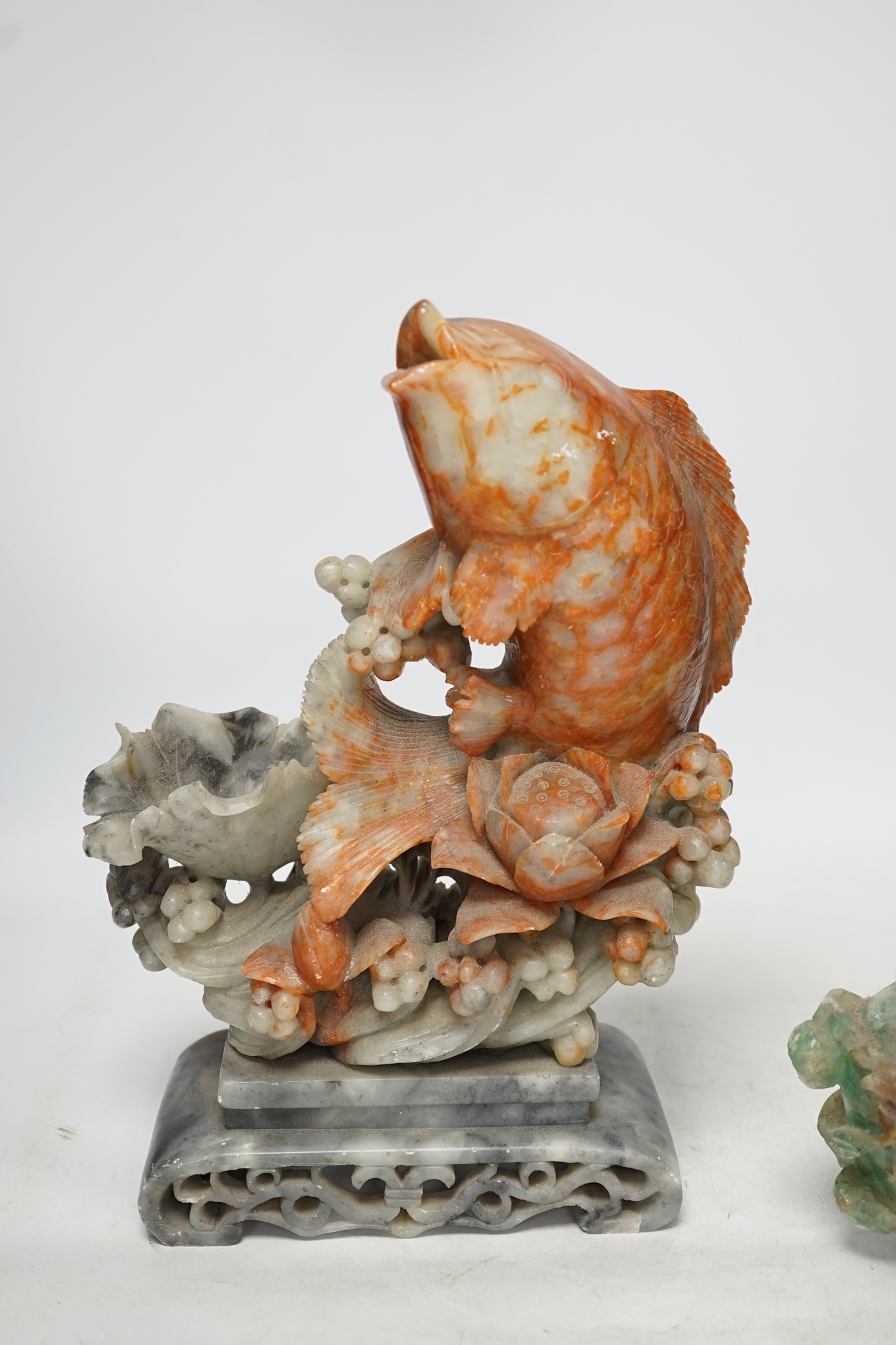 A Chinese carved soapstone figure of a leaping carp and a green quartz pot and cover, tallest 29.5cm high. Condition - fair